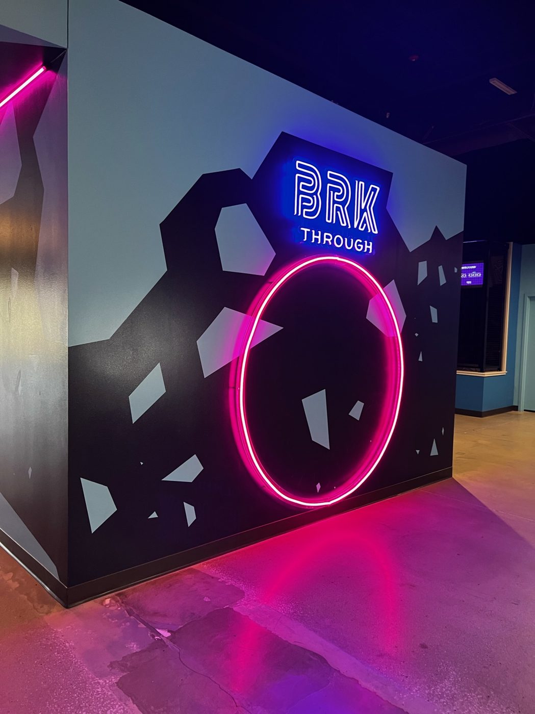 Entertainment venue interior — neon feature wall